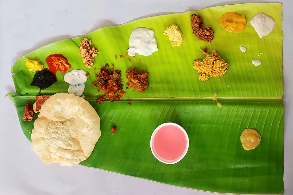 A full Sreekarthika sadhya on banana leaf — curries, pickles, pappadam and payasam in their places